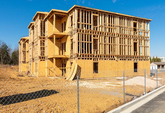 a close-up of temporary chain link fences enclosing a job site, signaling progress in the project's development in Gifford